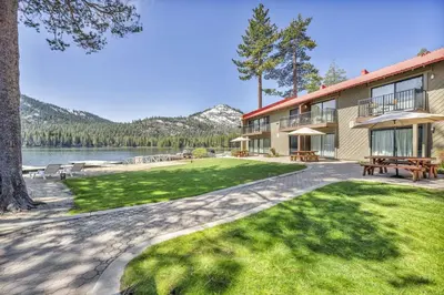 a building with a picnic table next to a lake at 132 Bldg C condo in Truckee