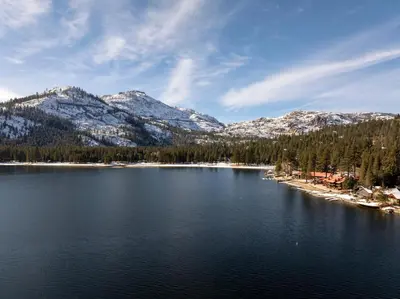 a view of a lake with snow covered mountains at 114 Bldg B condo in Truckee