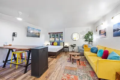 a living room with a yellow couch and a table at 114 Bldg B condo in Truckee