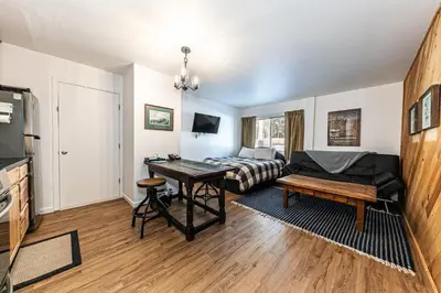 a living room with a bed and a table at 112 Bldg B condo in Truckee