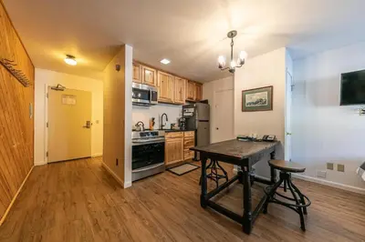 a kitchen with a wooden table in a room at 112 Bldg B condo in Truckee