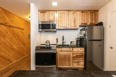 a kitchen with wooden cabinets and a stainless steel refrigerator at 112 Bldg B condo in Truckee