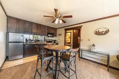 a kitchen with a table and chairs and a ceiling fan at 247 Bldg C condo in Truckee