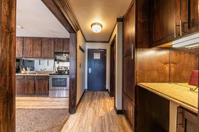 a kitchen with wooden cabinets and a hallway with a stove at 247 Bldg C condo in Truckee