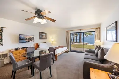 a bedroom with a bed and a living room at 145 Bldg C condo in Truckee
