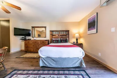 a bedroom with a large bed and a television at 215 Bldg B condo in Truckee