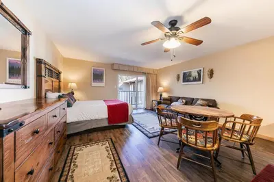 a bedroom with a bed and a table and chairs at 215 Bldg B condo in Truckee