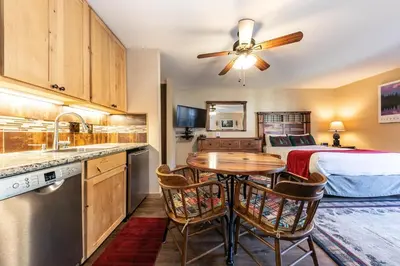 a kitchen and a bedroom with a bed and a table at 215 Bldg B condo in Truckee