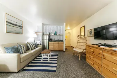 a living room with a couch and a flat screen tv at 211 Bldg B condo in Truckee