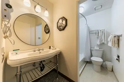 a bathroom with a sink and a mirror and a toilet at 211 Bldg B condo in Truckee