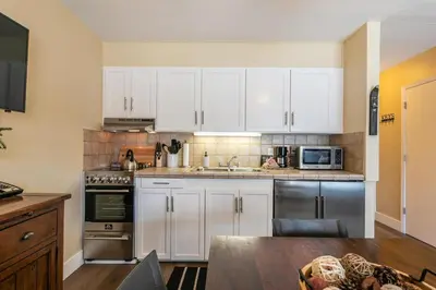 a kitchen with white cabinets and stainless steel appliances at 246 Bldg C condo in Truckee