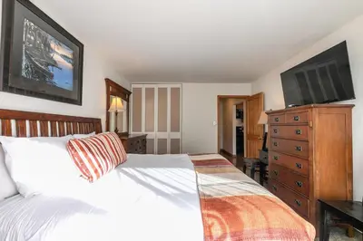 a bedroom with a bed and a flat screen tv at 222 Bldg B condo in Truckee