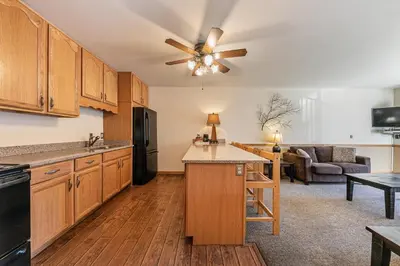 a kitchen with wooden cabinets and a ceiling fan at 222 Bldg B condo in Truckee