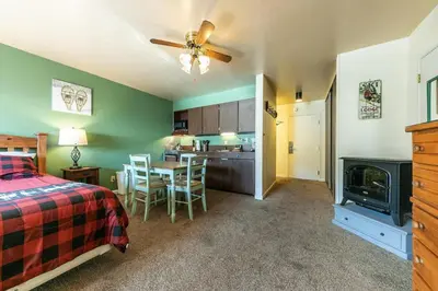 a bedroom with a bed and a kitchen with a table at 224 Bldg B condo in Truckee