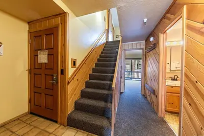 a hallway with a staircase in a house at 154 Bldg D townhouse in Truckee