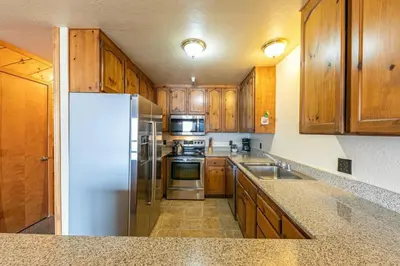 a kitchen with wooden cabinets and a white refrigerator at 154 Bldg D townhouse in Truckee