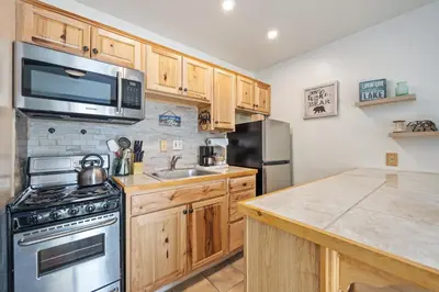 a kitchen with wooden cabinets and a stainless steel appliances at 223 Bldg B condo in Truckee