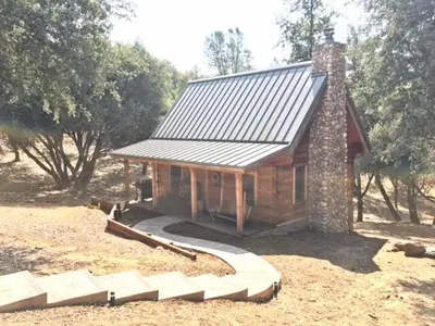 a small log cabin with a metal roof at Apple Valley Cabin in Sonora