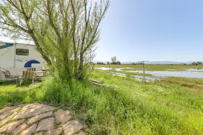 a rv parked next to a tree next to a river at 11 Mi to Heavenly Mtn Resort Getaway with Mtn Views in Gardnerville