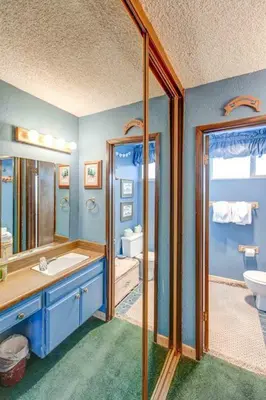 a blue bathroom with a sink and a mirror at Chamonix #093 - Near Skiing Hiking & More in Mammoth Lakes