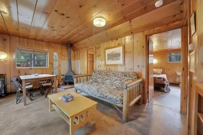 a living room with a couch and a table at Kit Carson Lodge in Kit Carson