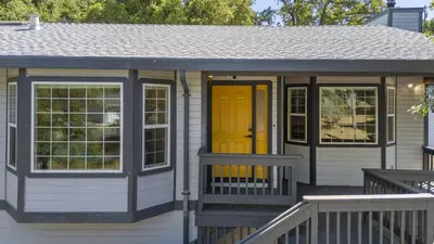 a small house with a yellow door and a porch at New Listing - 5bd 3ba Retreat for a large group in Groveland