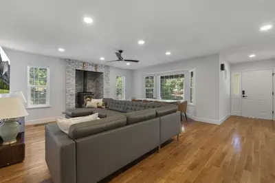 a living room with a couch and a fireplace at New Listing - 5bd 3ba Retreat for a large group in Groveland