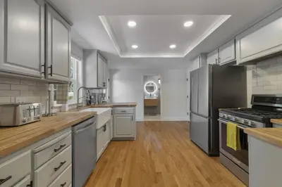 a large kitchen with stainless steel appliances and wooden floors at New Listing - 5bd 3ba Retreat for a large group in Groveland