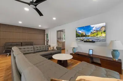a living room with a couch and a table at New Listing - 5bd 3ba Retreat for a large group in Groveland