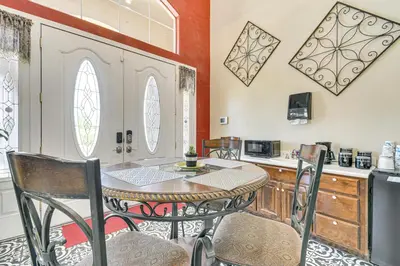 a kitchen with a table and chairs in a room at Golf, Fish and More Cozy Safari Unit in Atwater! in Atwater