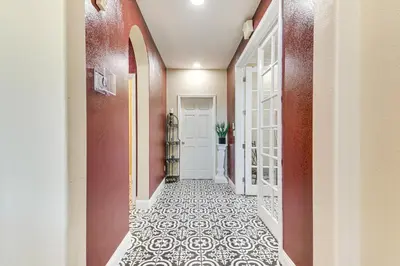 a hallway with a door and a tile floor at Golf, Fish and More Cozy Safari Unit in Atwater! in Atwater