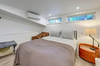 a bedroom with a bed and two windows at Kaweah River Cabin - Pool, Hot Tub, Movie Projector in Three Rivers