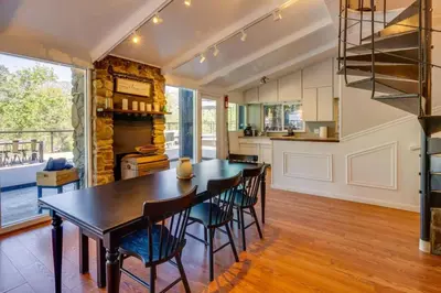 a kitchen and dining room with a table and chairs at Kaweah River Cabin - Pool, Hot Tub, Movie Projector in Three Rivers