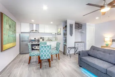 a living room with a couch and a table and chairs at Tranquil Riverfront Studio in Three Rivers