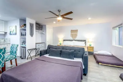 a living room with a couch and a bed at Tranquil Riverfront Studio in Three Rivers