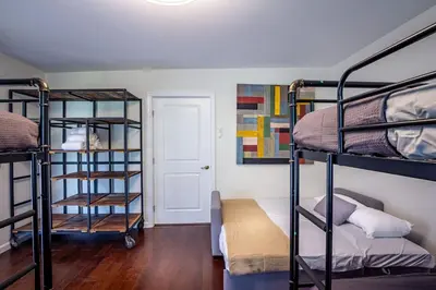 a room with three bunk beds and a door at Serene Riverfront Home - 150 yds from the River in Three Rivers