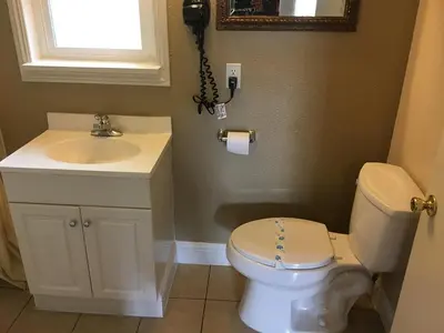 a bathroom with a toilet and a sink and a phone at colfax motorlodge in Colfax