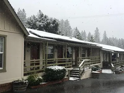 a house with snow on the roof of it at colfax motorlodge in Colfax