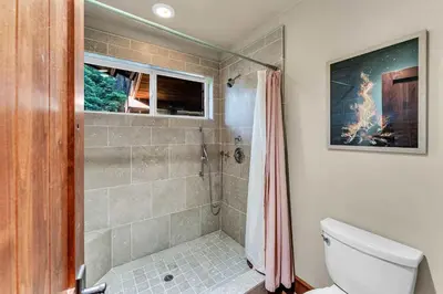 a bathroom with a shower and a toilet at Star Haven Game Room & Forest Views in Truckee