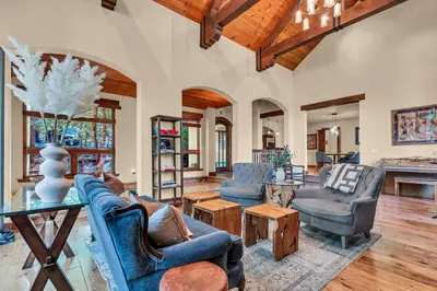 a living room with blue chairs and a table at Star Haven Game Room & Forest Views in Truckee
