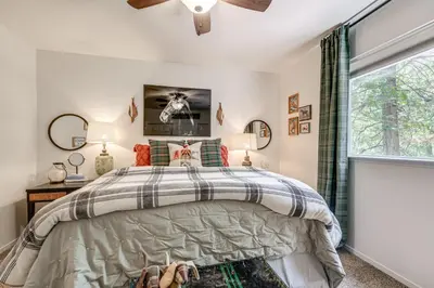 a bedroom with a bed and a window at Hike, Swim and Golf Home Near Dtwn Twain Harte in Twain Harte