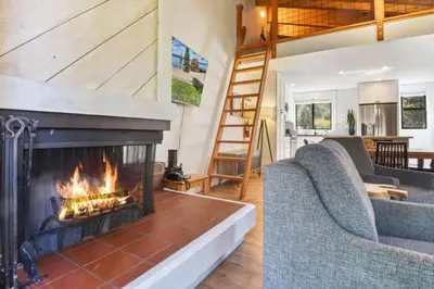 a living room with a fireplace and two couches at Northstar 2BR Walk to Village Bike Hike Rec Center in Truckee