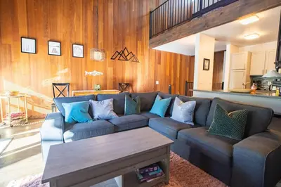 a living room with a couch and a table at 2xKing, Balconies, 350mbps. Loft, Near Northstar in Kings Beach