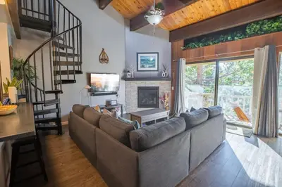 a living room with a couch and a fireplace at 2xKing, Balconies, 350mbps. Loft, Near Northstar in Kings Beach