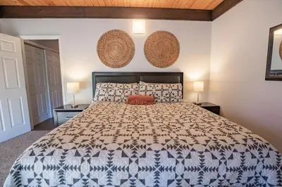 a bedroom with a large bed and two lamps at 2xKing, Balconies, 350mbps. Loft, Near Northstar in Kings Beach