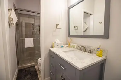a bathroom with a sink and a shower with a mirror at 2xKing, Balconies, 350mbps. Loft, Near Northstar in Kings Beach