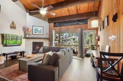 a living room with a couch and a fireplace at 2xKing, Balconies, 350mbps. Loft, Near Northstar in Kings Beach
