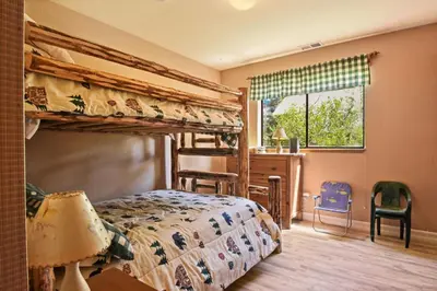 a bedroom with two bunk beds and a desk at Serene Tahoe Donner Cabin mins to Lake, Ski, Golf in Truckee