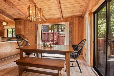 a dining room with a wooden table and chairs at Serene Tahoe Donner Cabin mins to Lake, Ski, Golf in Truckee