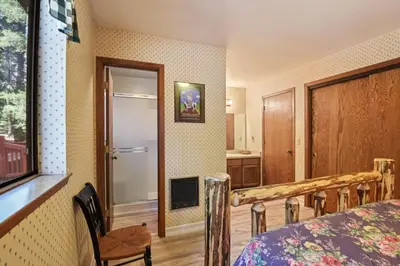 a bedroom with a bed and a table and a window at Serene Tahoe Donner Cabin mins to Lake, Ski, Golf in Truckee